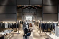 Darker menswear gallery below the timber roof at Beymen Tersane by OMA