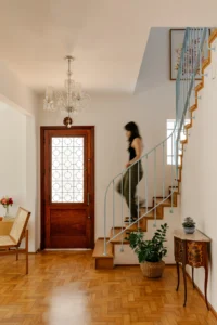 Entrance hall and restored staircase at BF2 House by Peninsula Arquitetura