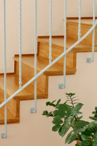 Detail of the restored timber stair and painted metal handrail at BF2 House