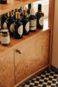 Bottles on the veneered cabinet at Chleboteka Okraglak by CUDO
