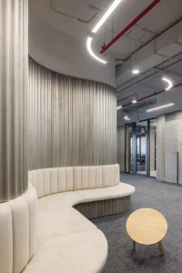 A curved membrane wall with seating at CNC and Active Offices