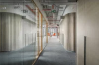 The long glazed corridor at CNC and Active Offices by Studio Reaktor