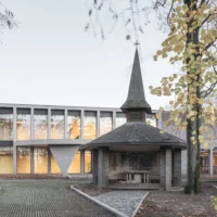 The chapel in front of the lit pavilion at College Cardinal Mercier