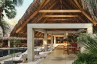 Looking through the palapa to the pool at Esh Hotel and Spa