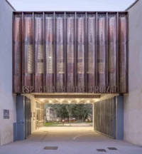 The porch of Espace Ambroise Croizat lit at dusk in Montpellier