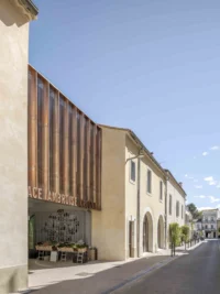 Timber screen over the restored street facade of Espace Ambroise Croizat