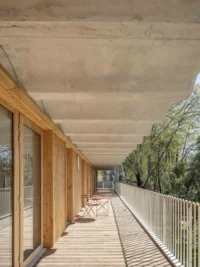 Walkway beneath the concrete vaults at Espace Ambroise Croizat