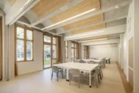 Meeting room under the cast concrete vaults at Espace Ambroise Croizat