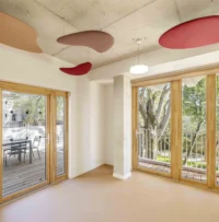 A workshop room with coloured ceiling discs at Espace Ambroise Croizat