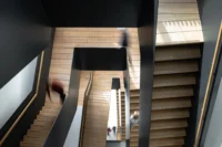 The sculptural atrium stair of Ferro Offices by GROUP A seen from above