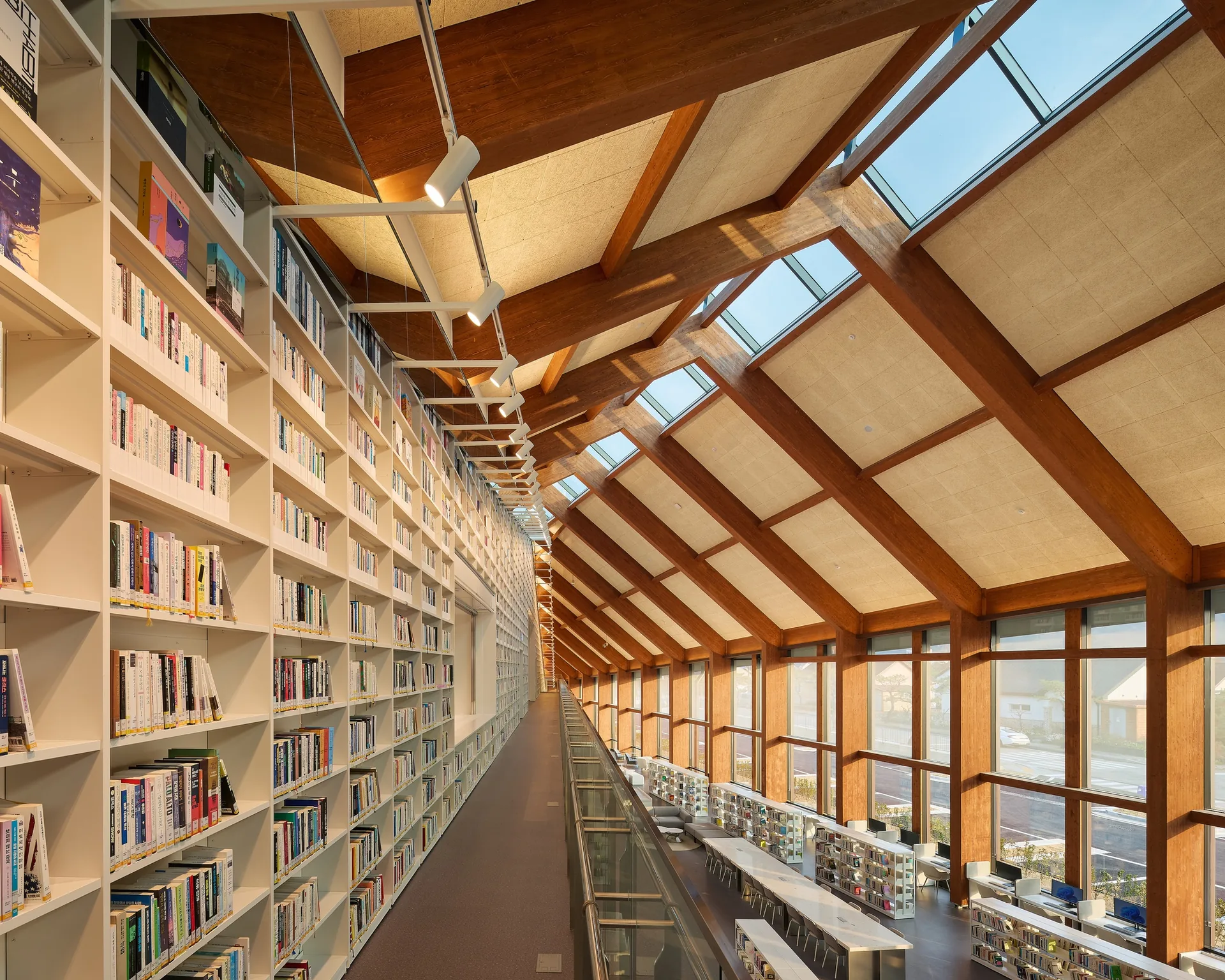The long bookshelf aisle under the heavy timber roof, Gochang Hwang Yunseok Library