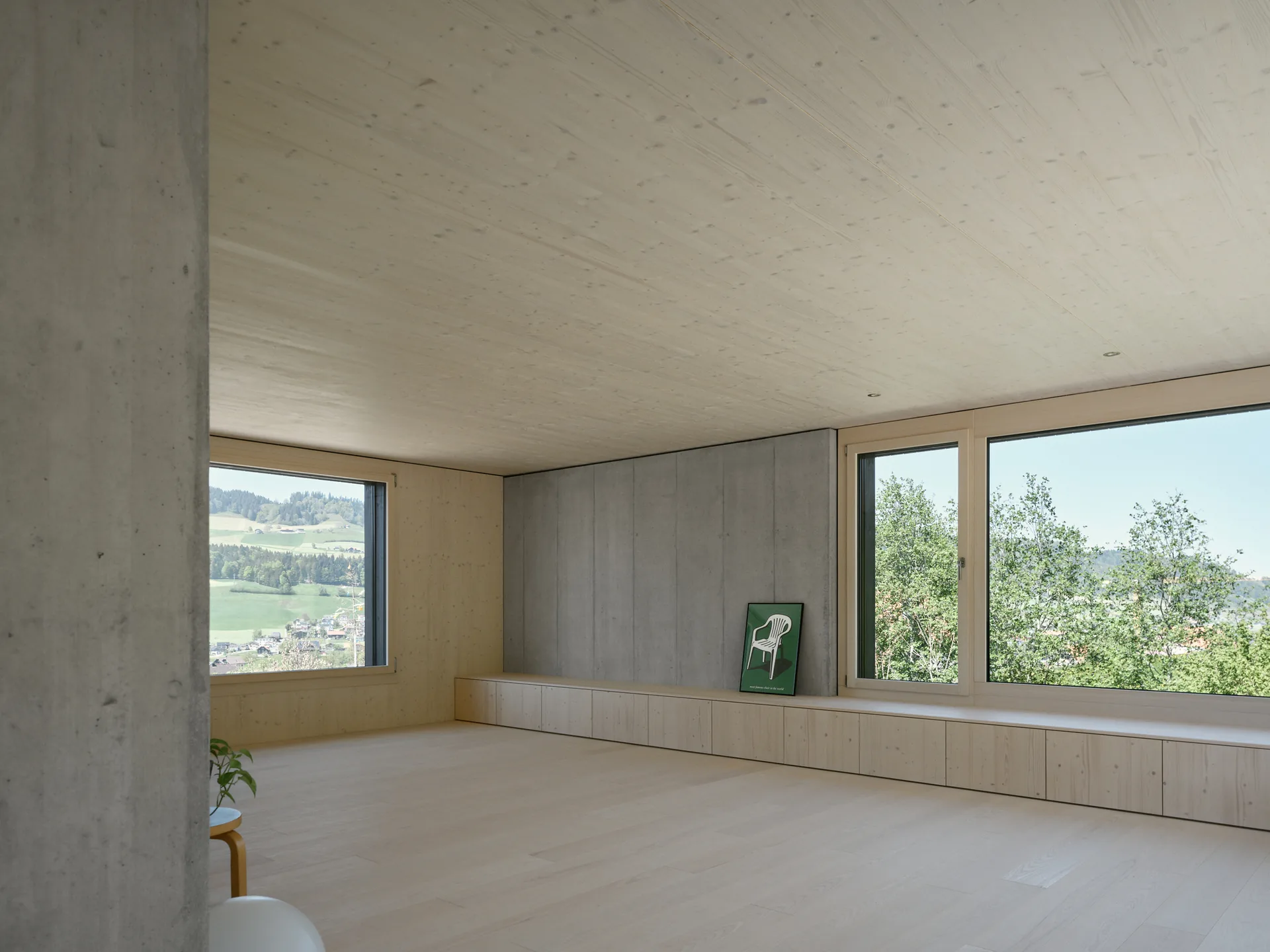 The long living space and strip window at House on Concrete Walls by dolmus Architekten