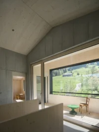 Bedroom level anteroom with its wide window, House on Concrete Walls by dolmus Architekten
