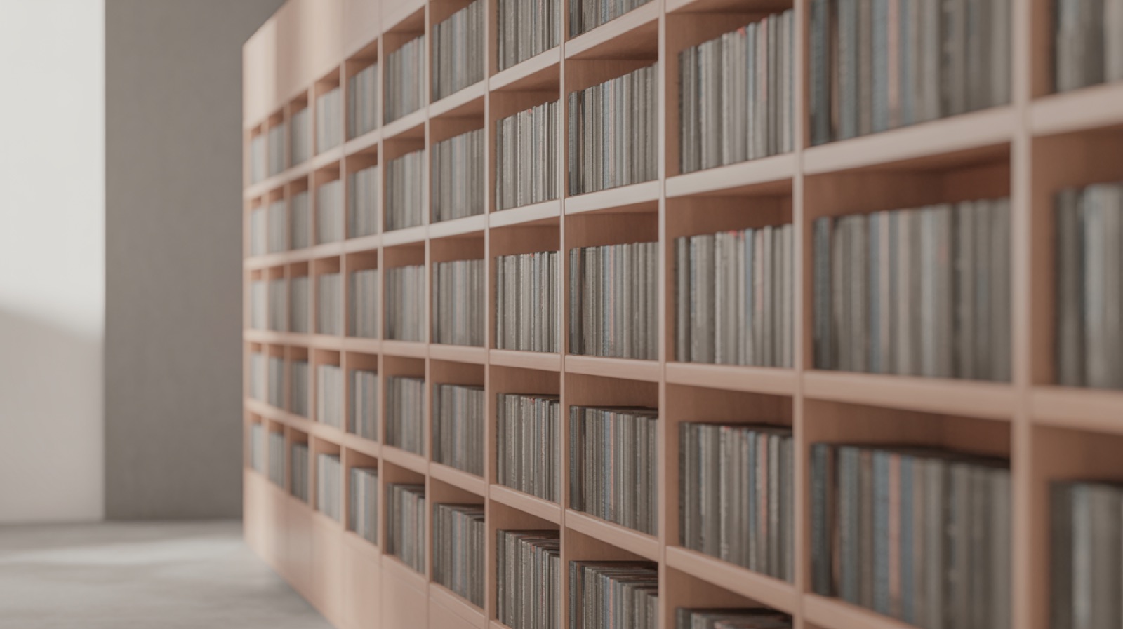 Wall of built-in timber shelving filled with books seen at shallow focus