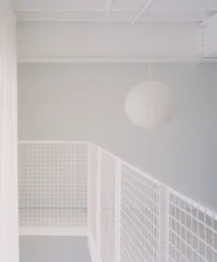 Paper globe above the steel mesh balustrade, Kerr Apartment by SSdH