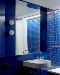 Basin and mirror in the blue tiled bathroom, Kerr Apartment by SSdH