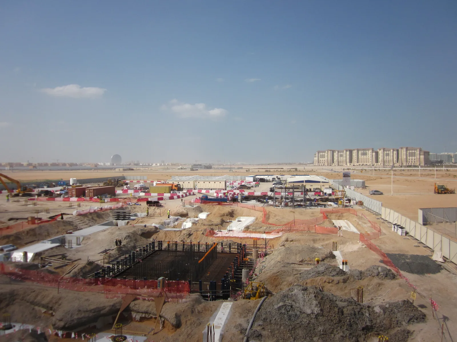 Masdar City under construction in January 2012, with open desert plots in front of finished buildings