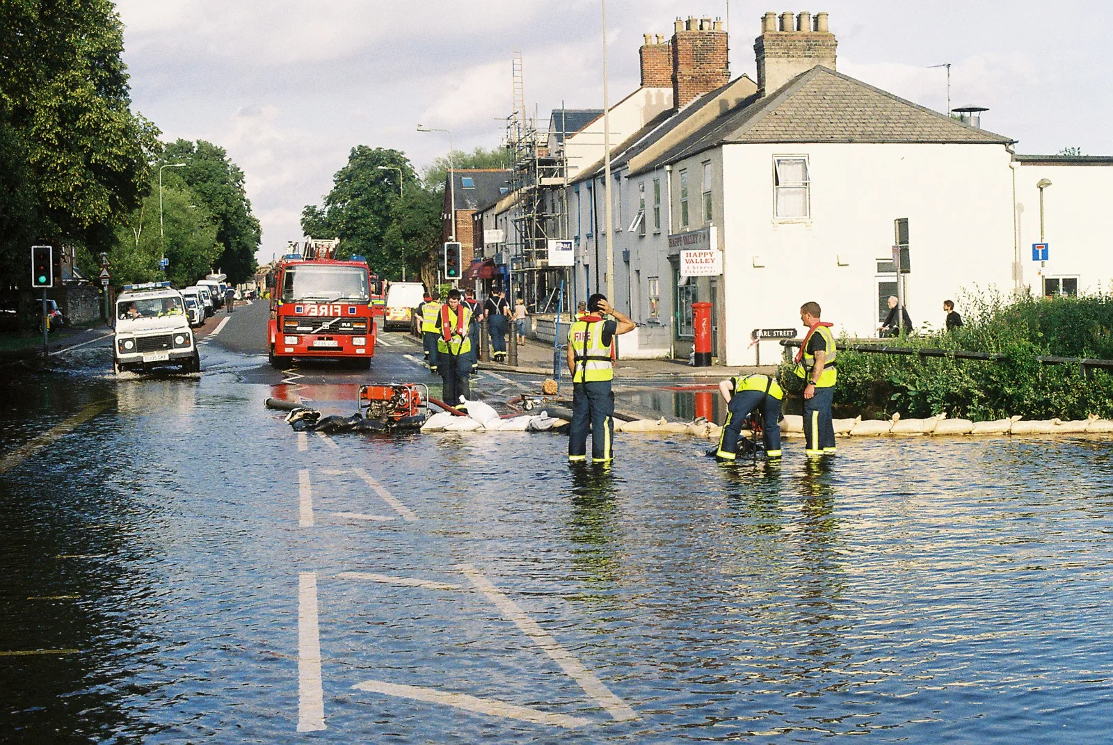 Floodwater covering Botley Road in Oxford during the 2007 floods, cars pushing through standing water