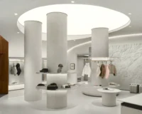 Main sales floor with terrazzo columns under a circular recess in the ceiling