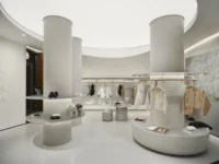 Two terrazzo columns with hanging rails between them under the ceiling recess