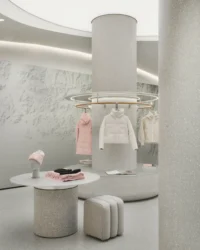 Round display podiums beneath the circular ceiling light