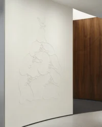 The Legacy Wall with its cartographic relief drawn into a pale surface