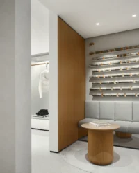 Fitting area with a bench, shelving and a round walnut table