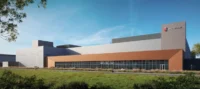Rendering of a large industrial building with orange and gray facade under a blue sky