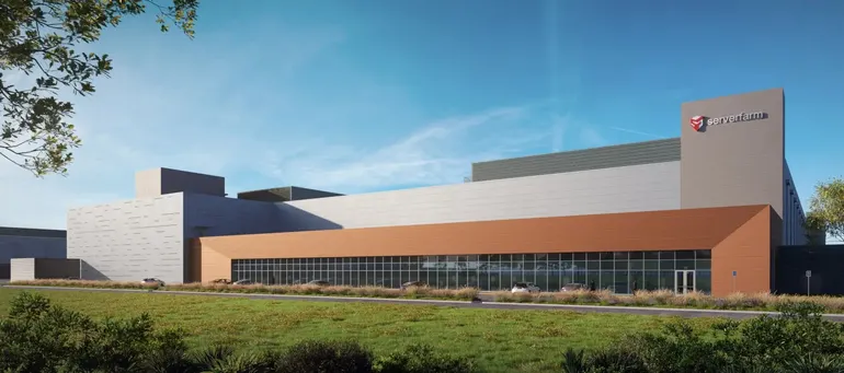 Rendering of a large industrial building with orange and gray facade under a blue sky
