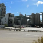 Holcim cement plant at Portland, Colorado, with its kiln and storage silos under an open sky