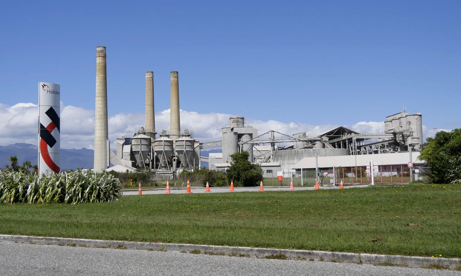 Holcim cement works at Westport in New Zealand, its silos standing beside the coast