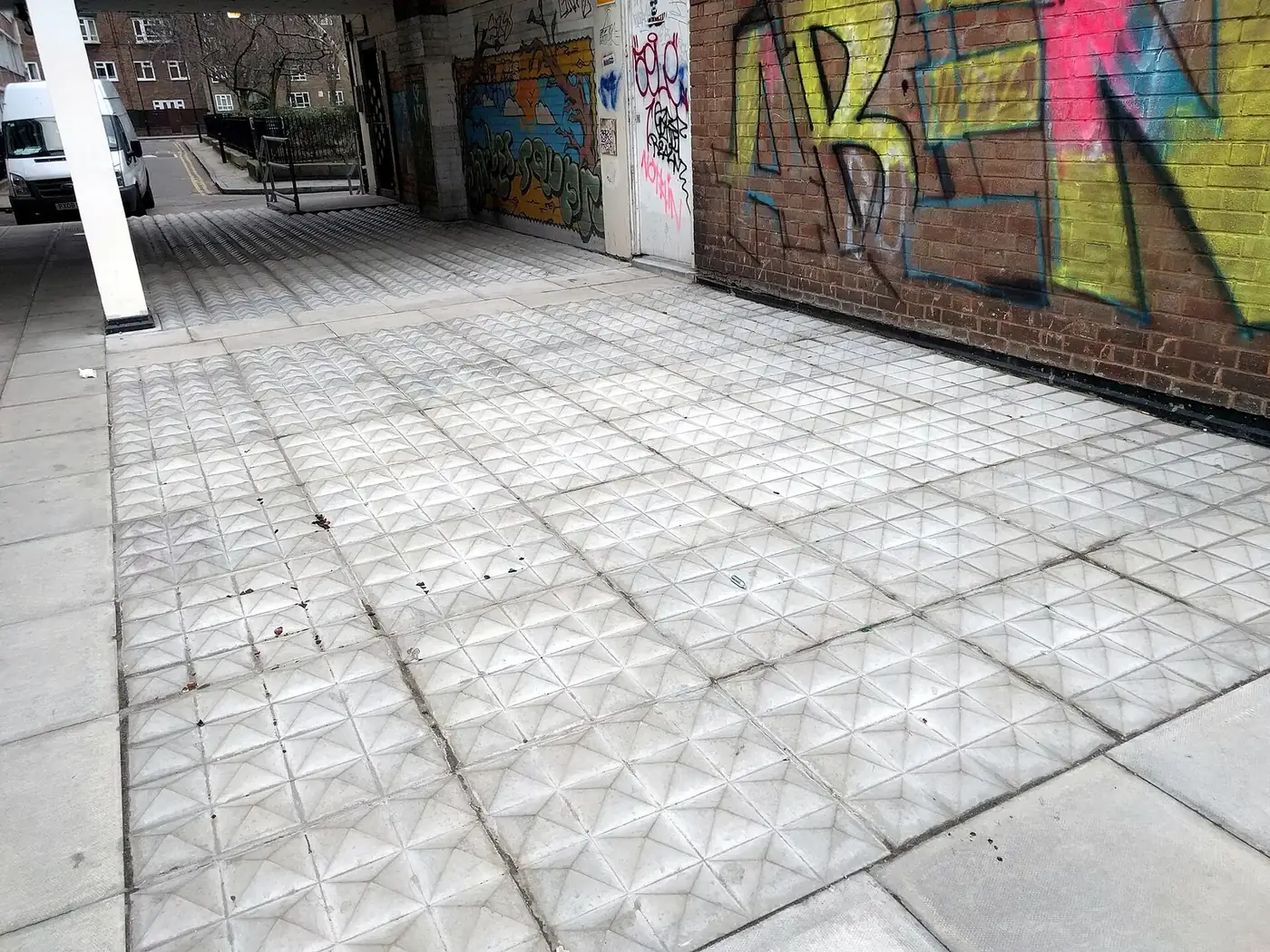 Metal anti-homeless floor spikes set into a doorway in Shoreditch, London