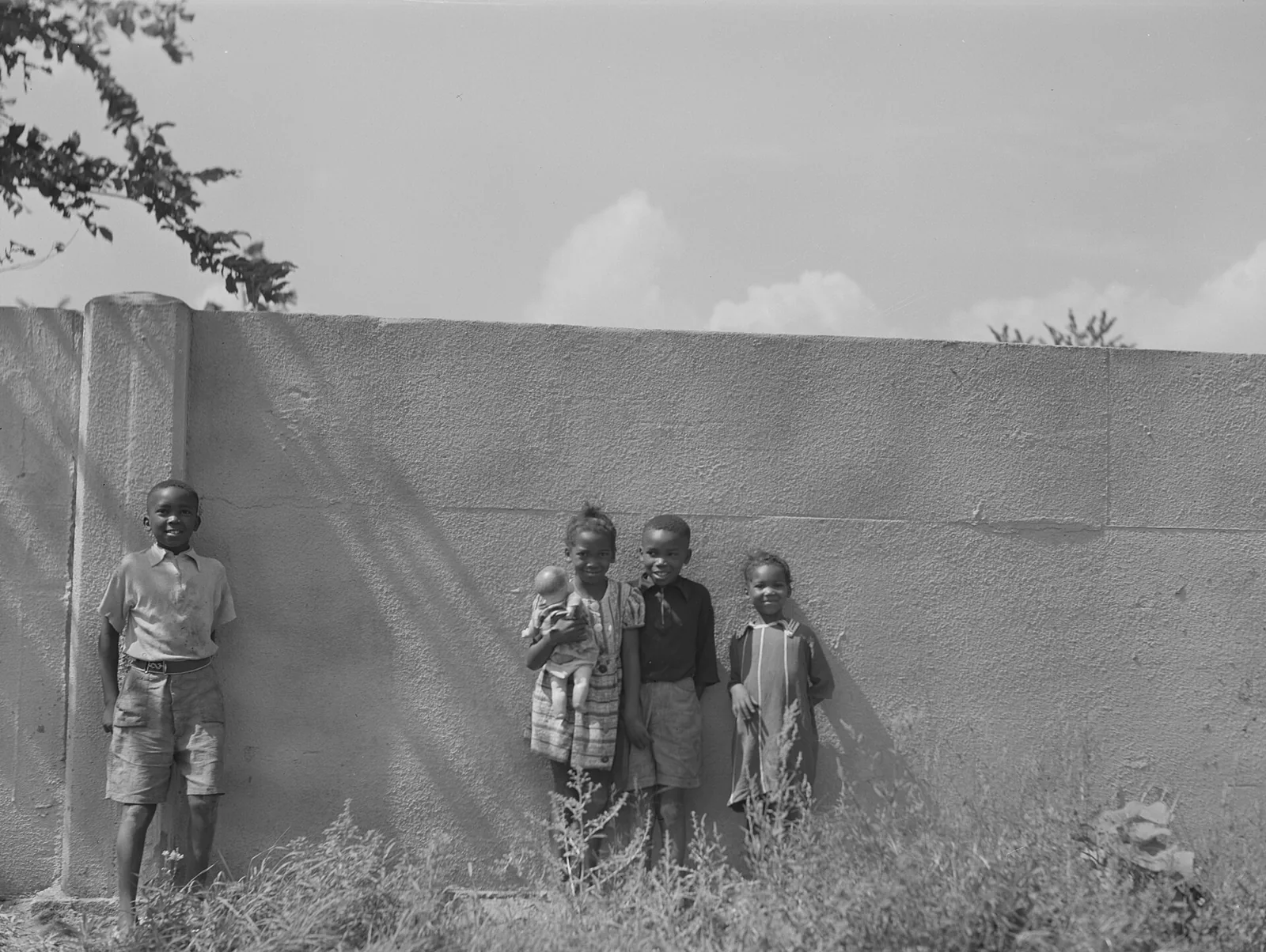 Four children in front of the Birwood Wall, Detroit, 1941, a hostile architecture wall built to separate neighborhoods