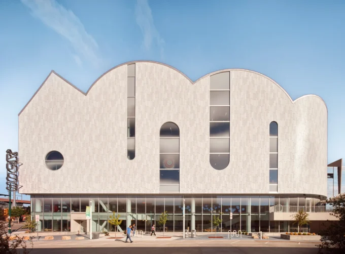 White barrel vaults with arched openings rising above a glazed ground floor