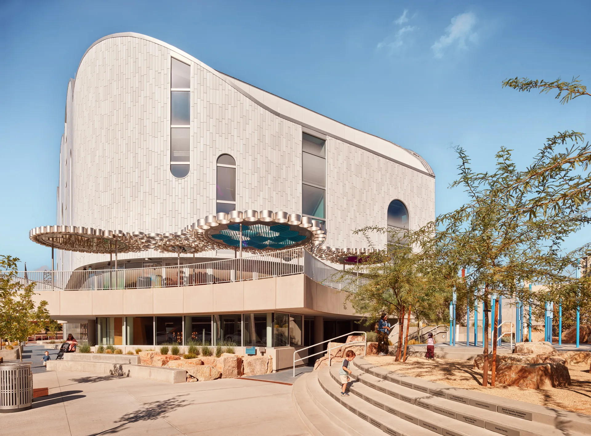 The building from the plaza with wide steps and desert planting in front