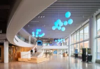 Lobby with a curved soffit and pale blue spheres suspended above the floor