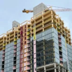Ascent in Milwaukee under construction, a mass timber tower with exposed glulam floors, concrete cores and a crane