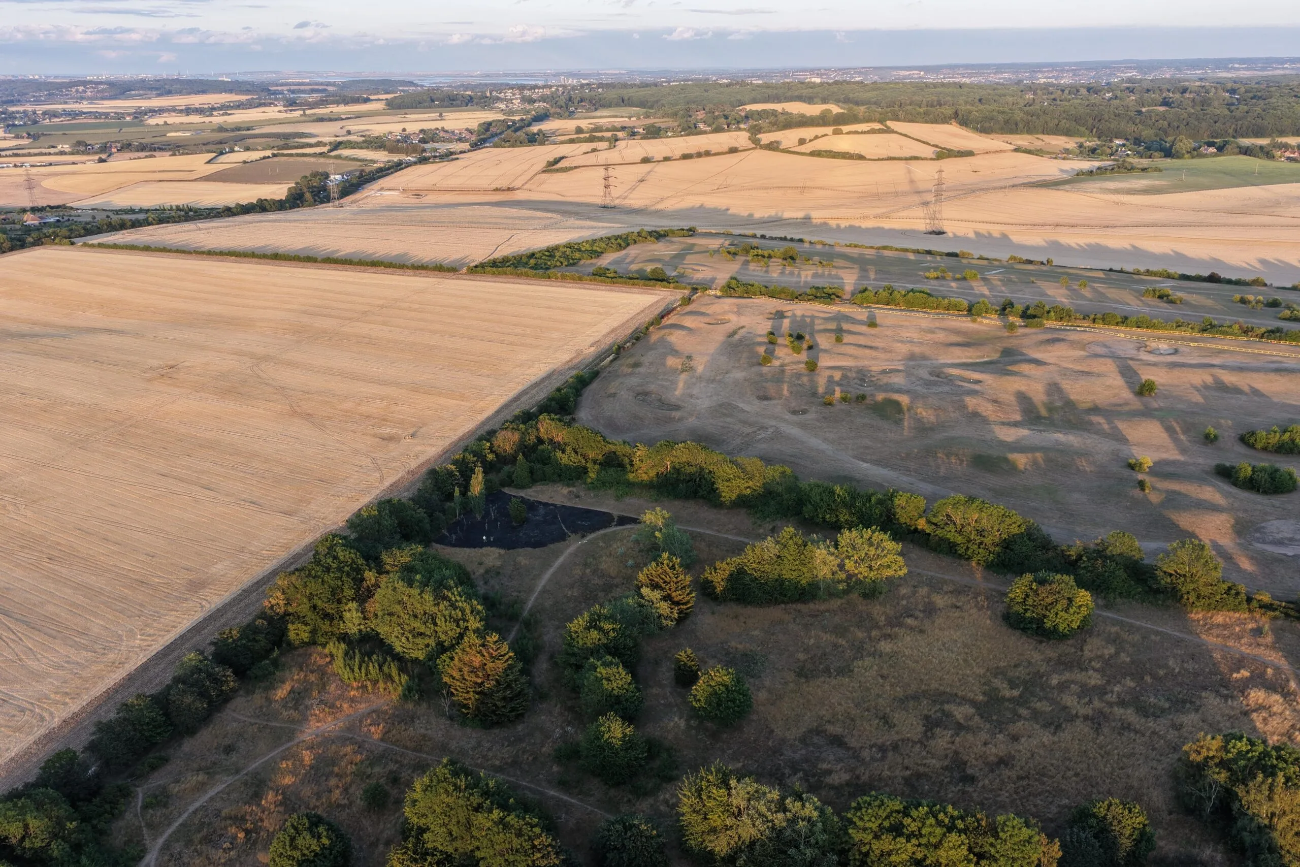 Aerial view of dry farmland with sparse vegetation