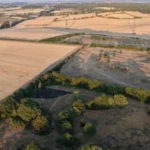 Aerial view of dry farmland with sparse vegetation