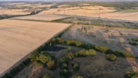 Aerial view of dry farmland with sparse vegetation