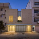 Nafas-e-No Clinic by Event Office, its preserved brick facade lit at dusk in Babol