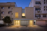 Nafas-e-No Clinic by Event Office, its preserved brick facade lit at dusk in Babol