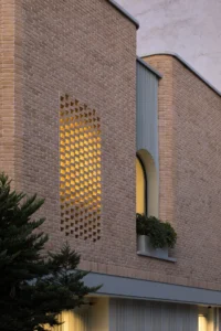 Perforated brick panel and planting on the facade of Nafas-e-No Clinic