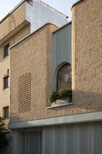 Brick and arched opening on the facade of Nafas-e-No Clinic by Event Office
