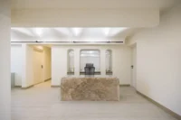 Stone reception block and arched niches at Nafas-e-No Clinic