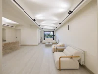 Long waiting room lit indirectly at Nafas-e-No Clinic by Event Office