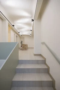 Stair and green handrail at Nafas-e-No Clinic by Event Office