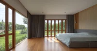 Bedroom facing the rice field at PIN'N PAN House by ForX Design Studio