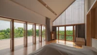 Bedroom under the sloped ceiling at PIN'N PAN House by ForX Design Studio