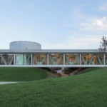 Production and Office Building Dubrovcan by MVA, its horizontal disk resting on three mounds
